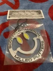 *new* Scotty Cameron 2024 Mardi Gras Smiley Face Bag Tag. Price: $180.00.